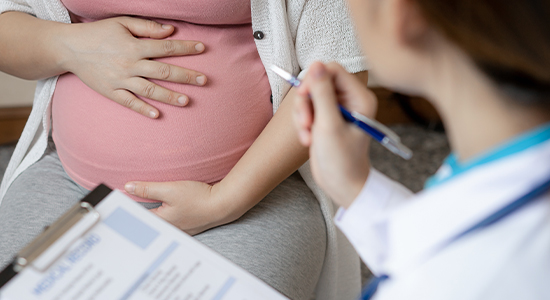 Doctor monitoring high-risk pregnancy patient